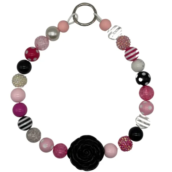 Colorful beaded bracelet with black flower accent.
