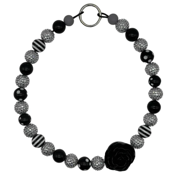 Black and silver beaded necklace with flower accent.